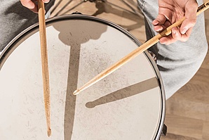 Spielende Hände mit Drumsticks auf einer Snaredrum