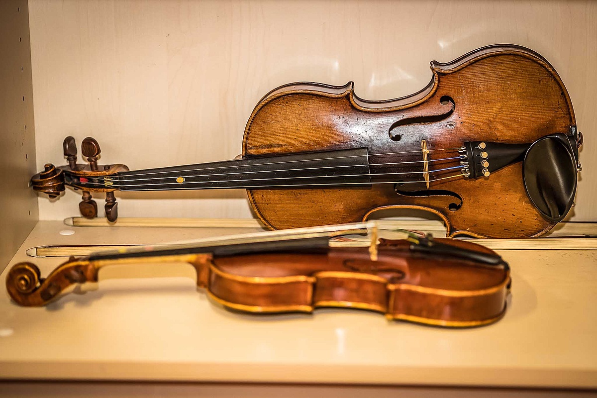 Eine Violine und eine Viola in einer Instrumentenvitrine